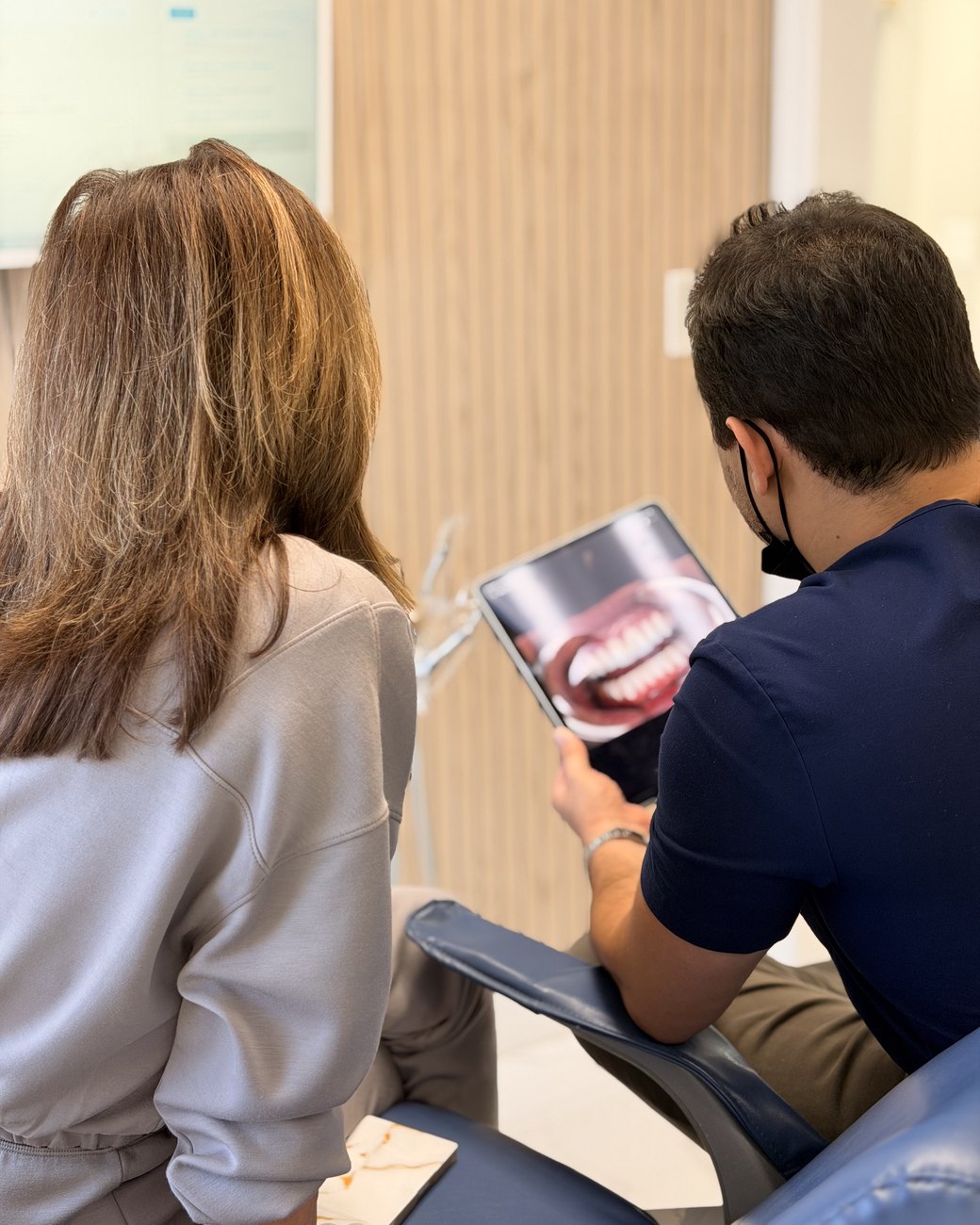 Dr. Johnny Moraes reviewing a smile with a patient